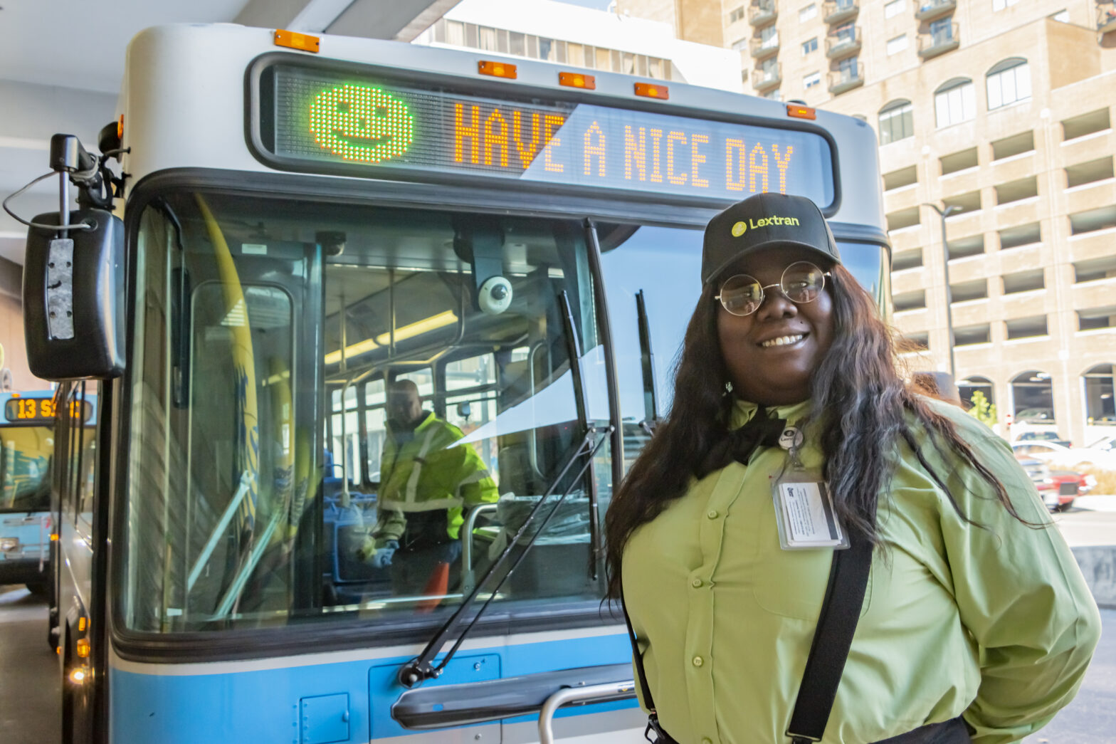 Bus Operator standing in front of Lextran vehicle